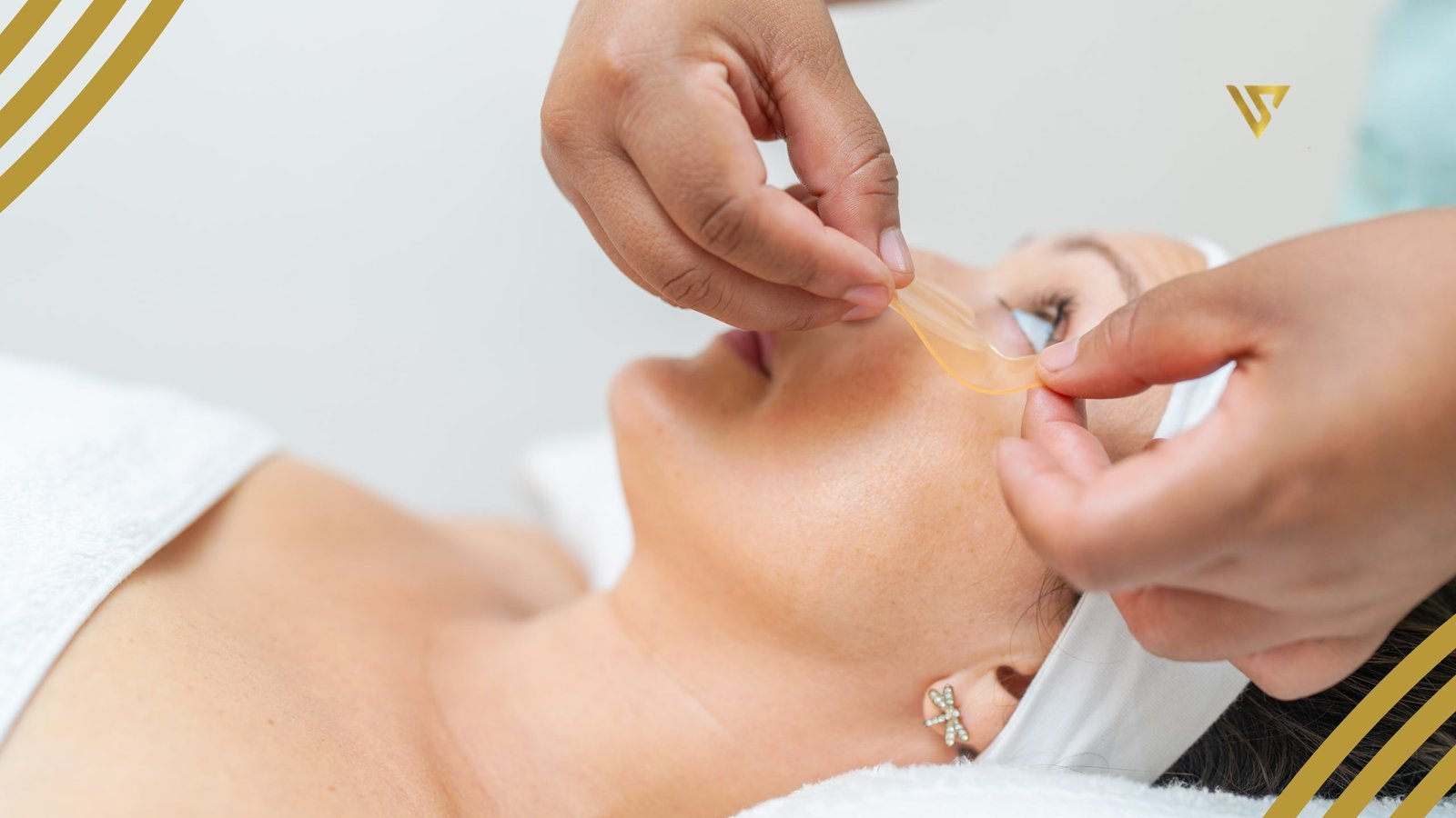 Person lying down with eyes open, hands applying treatment to the under-eye area dark circles treatment beauty spa by val