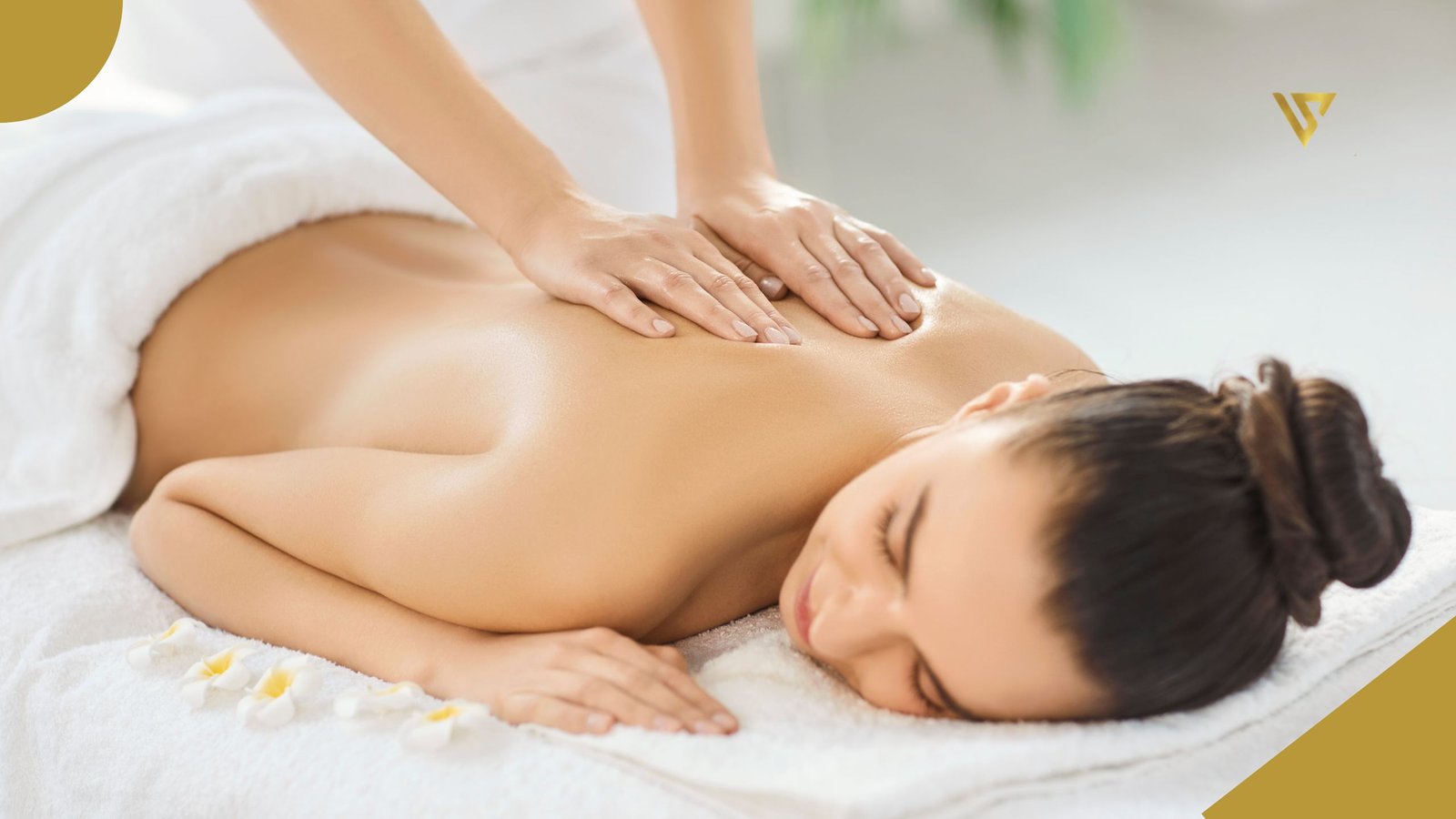 A young woman with dark brown hair tied back, lying face down on a treatment bed, her back exposed, a pair of hands resting on her back, and a white towel covering the lower part of her back, Back Facial Treatment Clearer Skin Starts Here, beauty spa by val