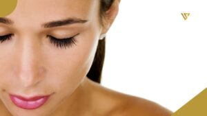 Face of a young woman with dark hair, eyes closed, pink lipstick, a white earring on the left ear, and bare shoulders, beauty spa by val, How Often Can You Get a Lash Lift Without Damaging Your Lashes